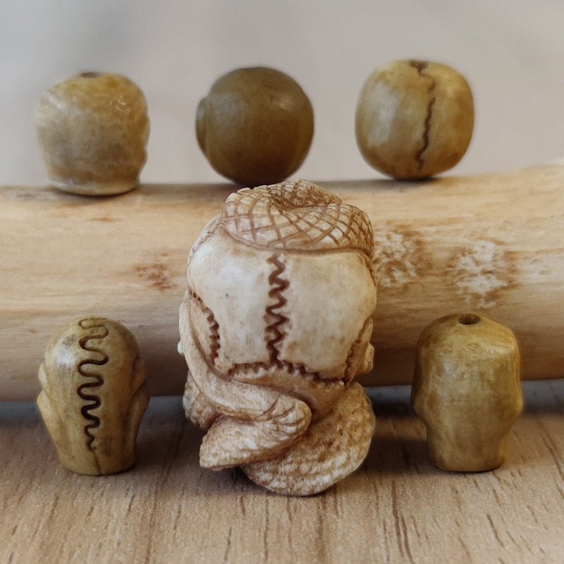 Antler-Carved Skull Bead with Coiled Serpent