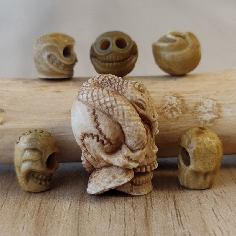 Antler-Carved Skull Bead with Coiled Serpent